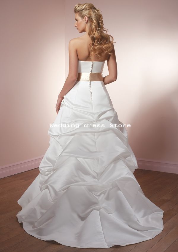 white gown with red ribbon